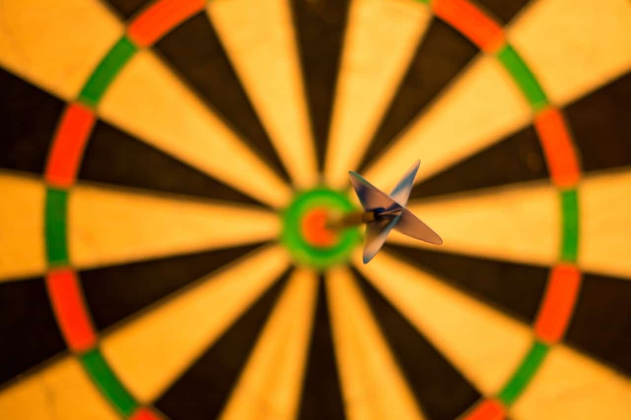 A dartboard with an arrow in the bullseye